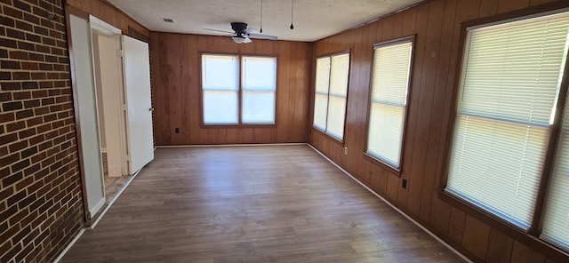 1526 Barcelona Dr, Columbus, GA 31907 - unfurnished sunroom featuring brick wall, wood finished floors, and wooden walls