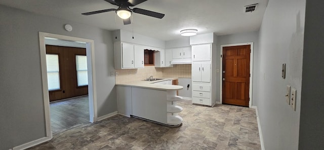 1526 Barcelona Dr, Columbus, GA 31907 - kitchen with stone finish floor, visible vents, a ceiling fan, and white cabinetry
