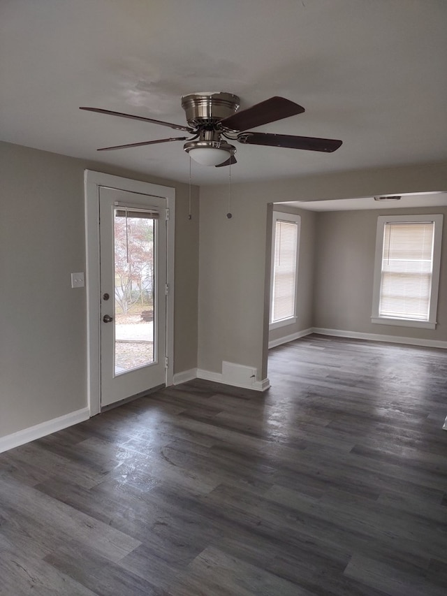 unfurnished room with dark hardwood / wood-style flooring and ceiling fan