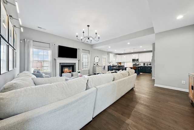 2013 Hereford Ln, Columbus, GA 31904 - living area with dark wood-type flooring, a chandelier, a tiled fireplace, baseboards, and recessed lighting