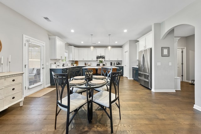 2013 Hereford Ln, Columbus, GA 31904 - dining area featuring arched walkways, baseboards, dark wood-style floors, and recessed lighting