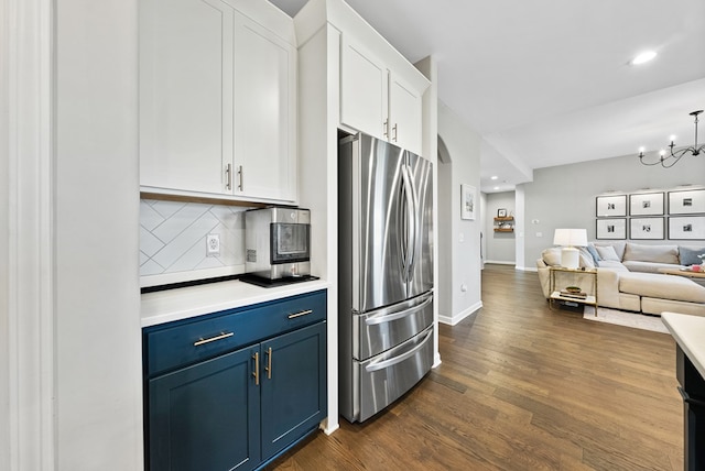 2013 Hereford Ln, Columbus, GA 31904 - kitchen featuring freestanding refrigerator, blue cabinets, tasteful backsplash, white cabinets, and light countertops