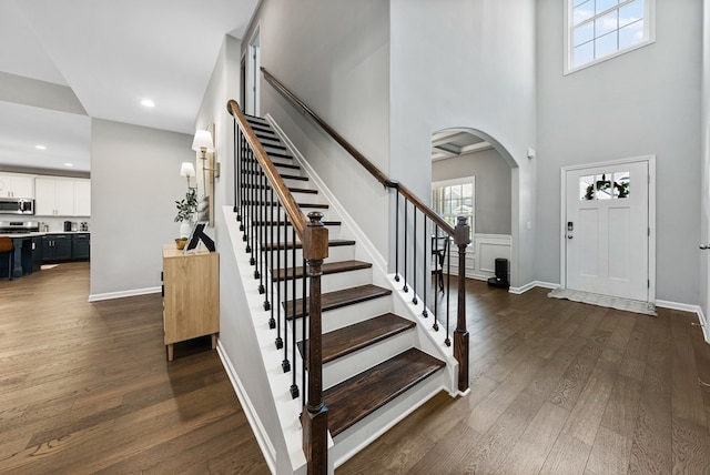 2013 Hereford Ln, Columbus, GA 31904 - foyer featuring arched walkways, dark wood-style flooring, stairs, recessed lighting, and a towering ceiling