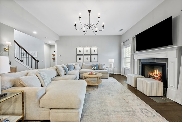 2013 Hereford Ln, Columbus, GA 31904 - living room featuring recessed lighting, dark wood-style flooring, stairway, a chandelier, and a tiled fireplace