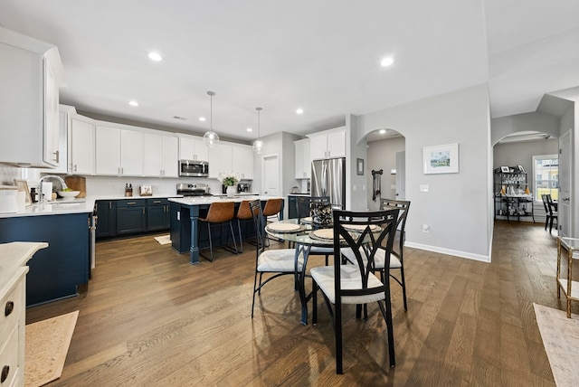 2013 Hereford Ln, Columbus, GA 31904 - dining area featuring arched walkways, wood finished floors, and recessed lighting