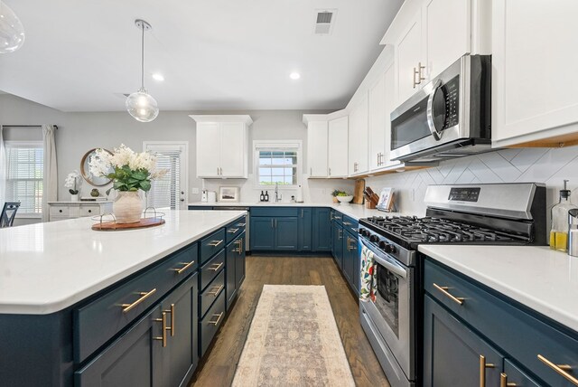 2013 Hereford Ln, Columbus, GA 31904 - kitchen with appliances with stainless steel finishes, blue cabinets, white cabinets, light countertops, and recessed lighting