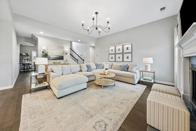 2013 Hereford Ln, Columbus, GA 31904 - living area featuring arched walkways, recessed lighting, a chandelier, dark wood-style floors, and a fireplace