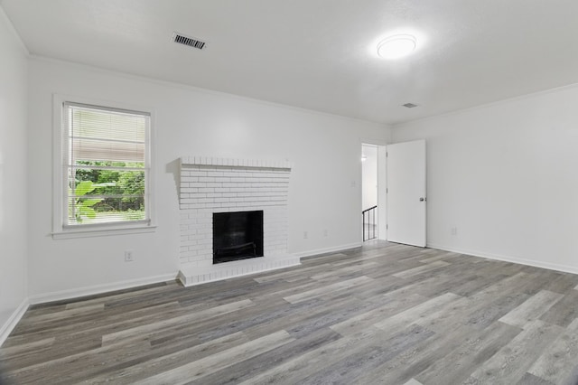 5202 Lakeshore Rd, Columbus, GA 31907 - unfurnished living room with crown molding, wood finished floors, a brick fireplace, and baseboards