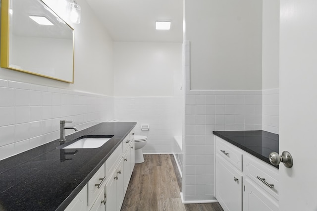 5202 Lakeshore Rd, Columbus, GA 31907 - bathroom with tile walls, vanity, toilet, wood finished floors, and wainscoting