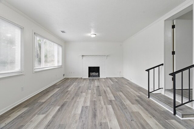 5202 Lakeshore Rd, Columbus, GA 31907 - unfurnished living room featuring light wood-style floors, a fireplace, crown molding, baseboards, and stairs