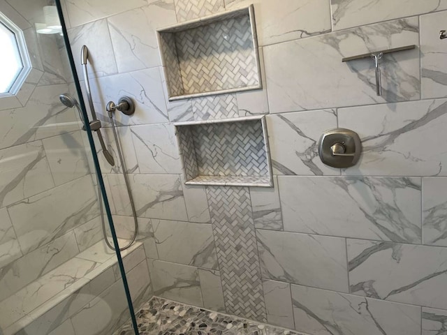 bathroom with tiled shower