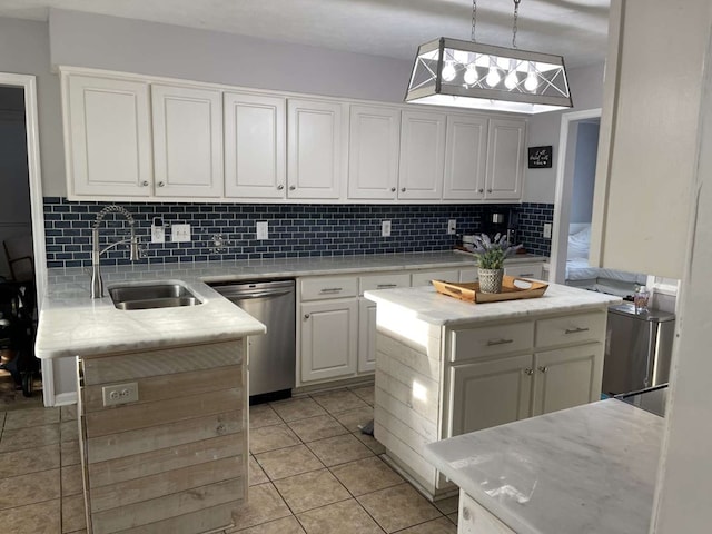 kitchen featuring pendant lighting, stainless steel dishwasher, white cabinetry, and a kitchen island