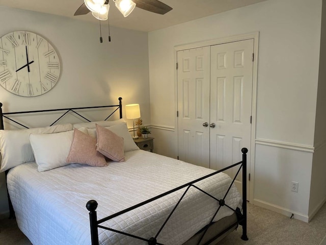 carpeted bedroom with ceiling fan and a closet