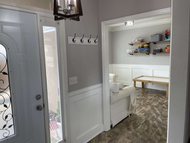 mudroom featuring ornamental molding and an inviting chandelier