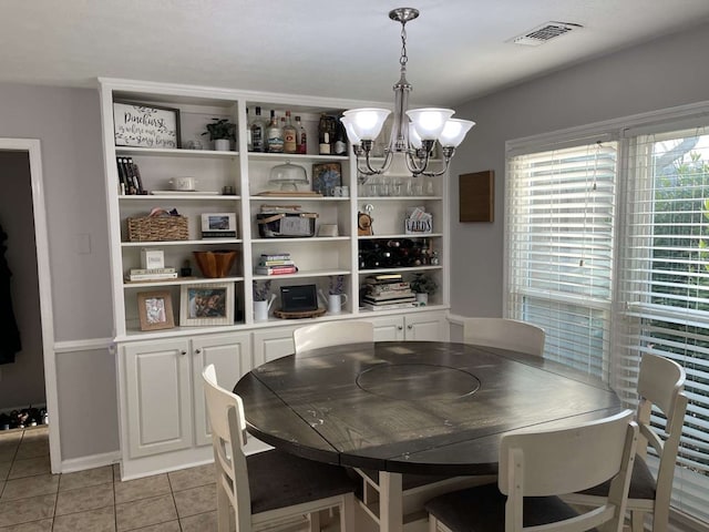 dining space featuring an inviting chandelier and light tile patterned floors