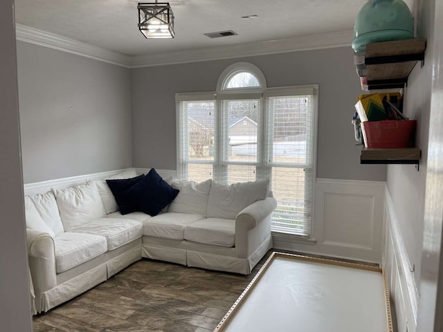 living room with hardwood / wood-style floors and ornamental molding