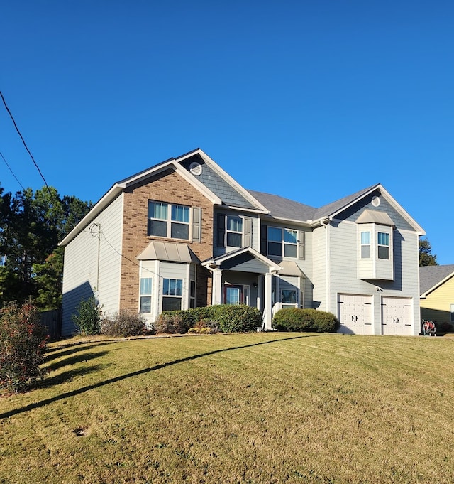 view of front of house featuring a garage, a front lawn, and brick siding