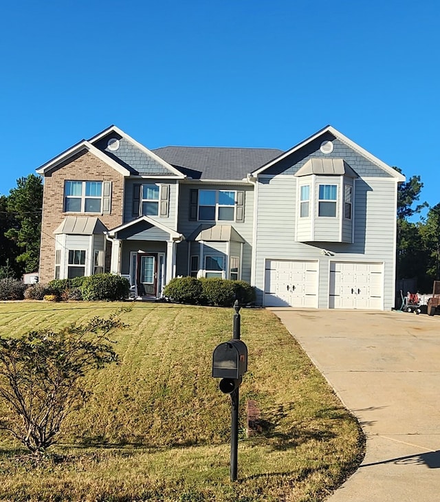 view of front of house with an attached garage, a front lawn, and concrete driveway