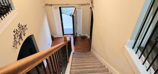 stairs with baseboards and wood finished floors