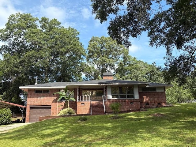 1403 Forest Dr, Columbus, GA 31907 - view of front of home with brick siding, an attached garage, and a front yard