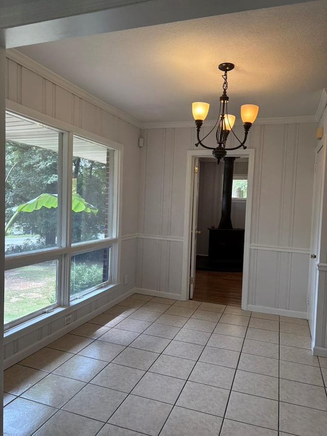 1403 Forest Dr, Columbus, GA 31907 - unfurnished dining area featuring a decorative wall, ornamental molding, light tile patterned flooring, healthy amount of natural light, and a chandelier