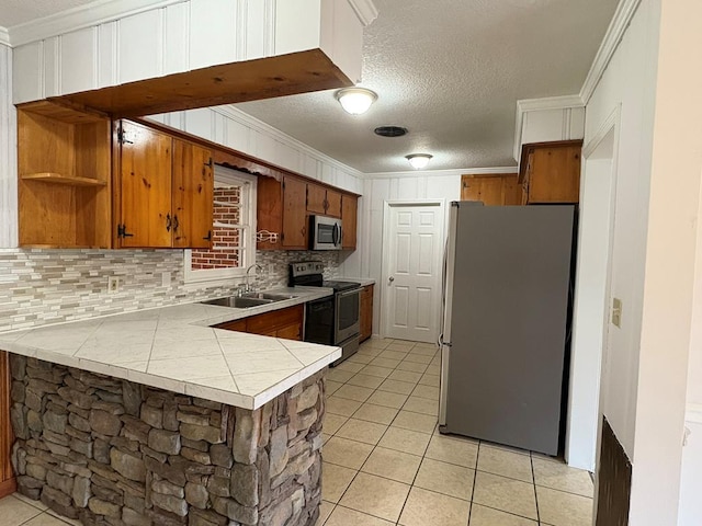 1403 Forest Dr, Columbus, GA 31907 - kitchen featuring appliances with stainless steel finishes, decorative backsplash, light tile patterned floors, crown molding, and brown cabinetry