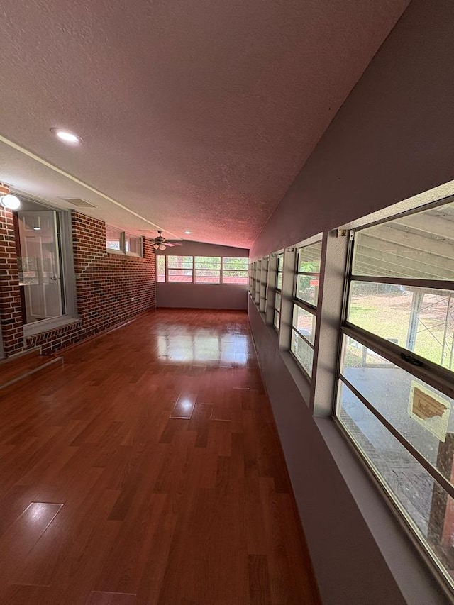 1403 Forest Dr, Columbus, GA 31907 - hall featuring a textured ceiling, wood finished floors, brick wall, and recessed lighting