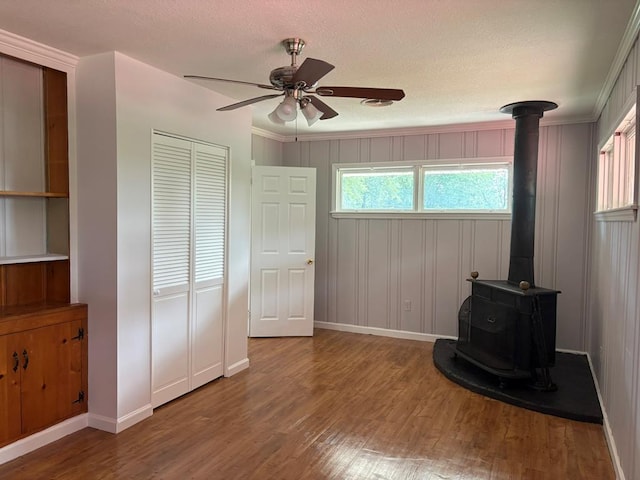 1403 Forest Dr, Columbus, GA 31907 - unfurnished bedroom featuring a wood stove, wood finished floors, a closet, and a textured ceiling