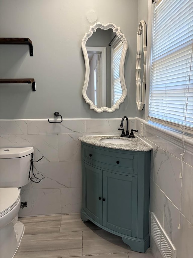 1403 Forest Dr, Columbus, GA 31907 - bathroom with tile walls, vanity, and a wainscoted wall