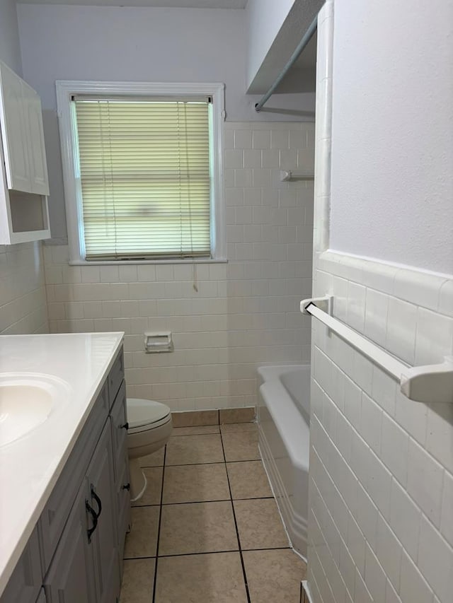 1403 Forest Dr, Columbus, GA 31907 - bathroom with tile walls, a bath, vanity, plenty of natural light, and a wainscoted wall