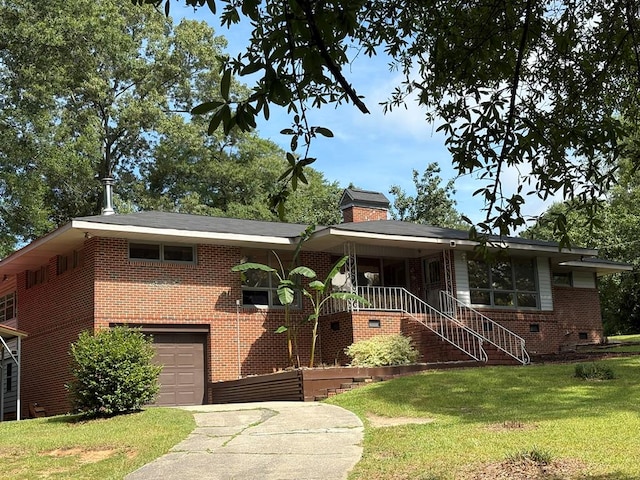 1403 Forest Dr, Columbus, GA 31907 - view of front of home featuring a front yard, concrete driveway, an attached garage, brick siding, and a chimney