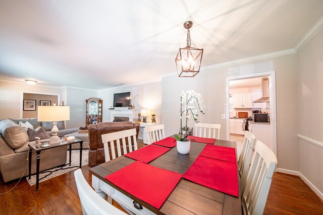 3422 Malatche Dr, Columbus, GA 31907 - dining room featuring a chandelier, wood finished floors, ornamental molding, and a fireplace