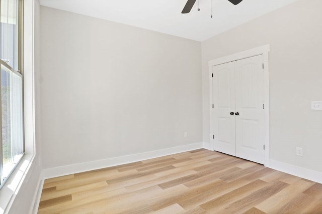 empty room featuring ceiling fan and light hardwood / wood-style floors