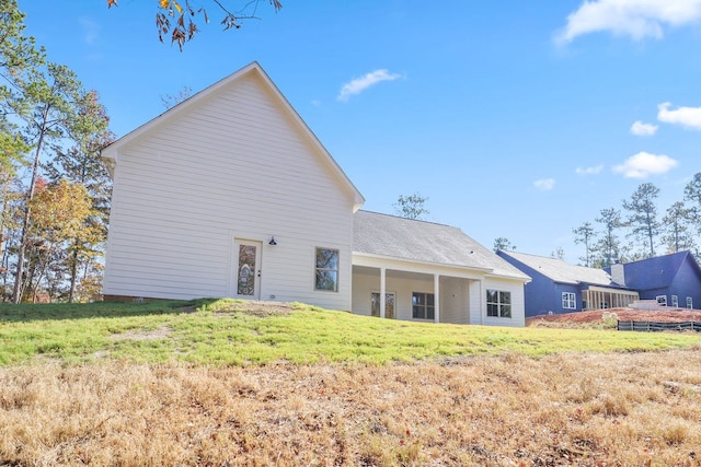 rear view of house with a yard