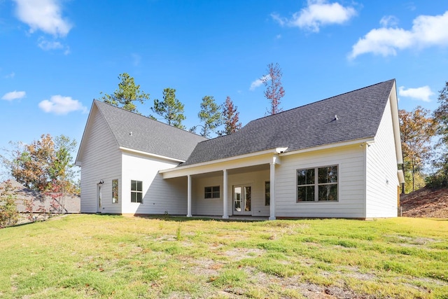 rear view of property with a yard