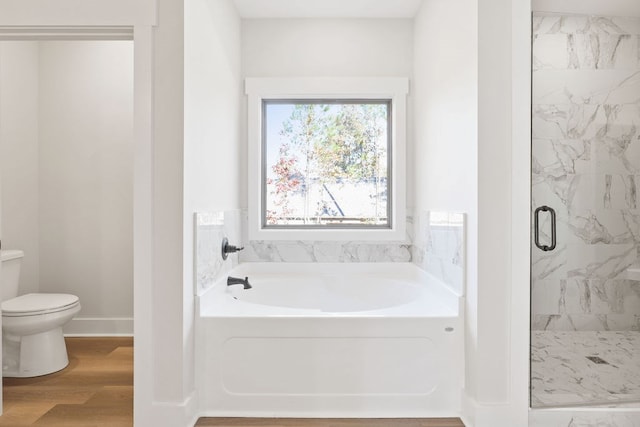 bathroom featuring separate shower and tub, hardwood / wood-style floors, and toilet