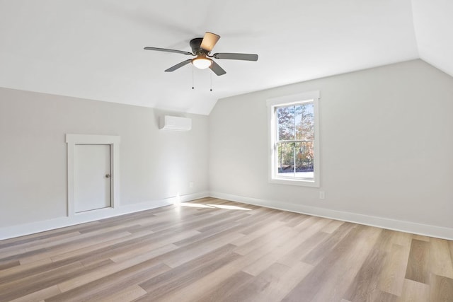 bonus room featuring light hardwood / wood-style flooring, ceiling fan, lofted ceiling, and a wall unit AC