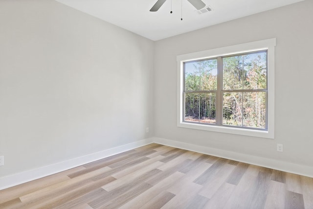 spare room featuring light hardwood / wood-style floors, plenty of natural light, and ceiling fan