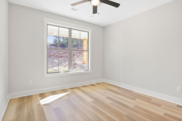 unfurnished room featuring light wood-type flooring, a wealth of natural light, and ceiling fan