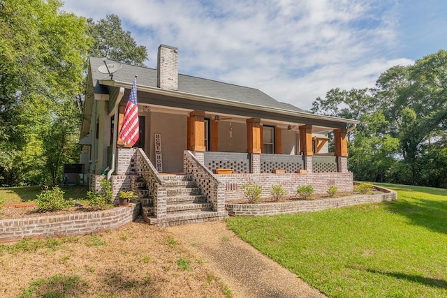 back of property with a porch and a yard