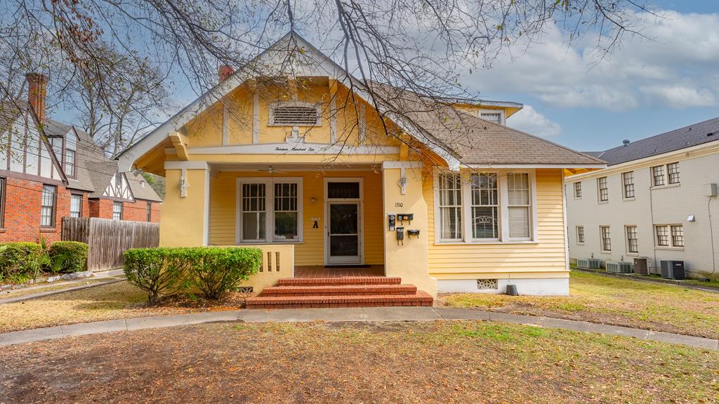 bungalow-style home with cooling unit, covered porch, fence, roof with shingles, and crawl space