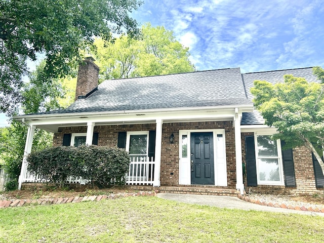 7396 Cedar Creek Loop, Columbus, GA 31904 - view of front facade featuring brick siding, covered porch, a chimney, a front lawn, and a shingled roof