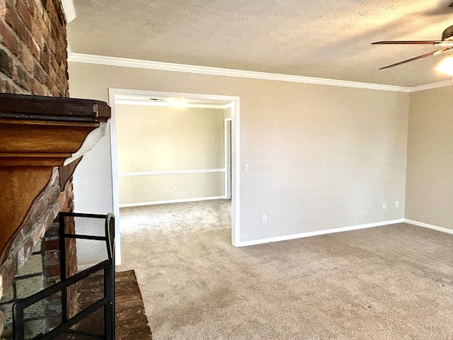 carpeted empty room with a textured ceiling, ornamental molding, a ceiling fan, and baseboards