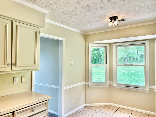 7396 Cedar Creek Loop, Columbus, GA 31904 - kitchen with light countertops, light tile patterned floors, cream cabinetry, baseboards, and a textured ceiling