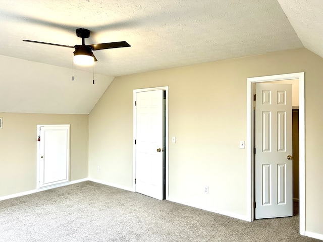 bonus room featuring baseboards, a ceiling fan, light colored carpet, lofted ceiling, and a textured ceiling