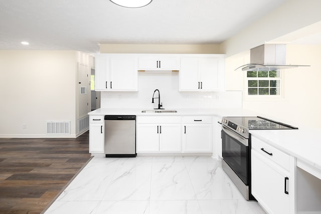 754 Wright Dr, Columbus, GA 31907 - kitchen with appliances with stainless steel finishes, recessed lighting, white cabinetry, island exhaust hood, and light countertops