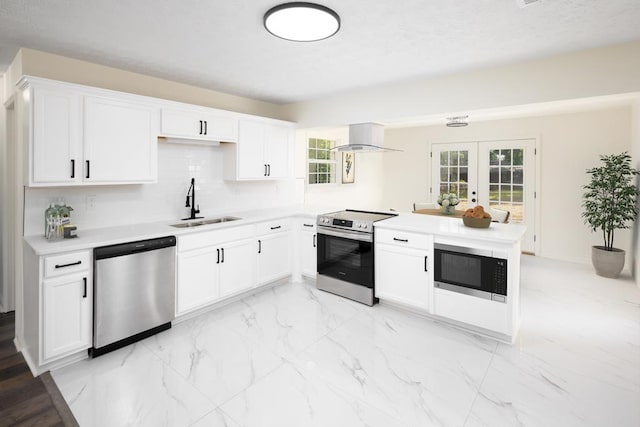 754 Wright Dr, Columbus, GA 31907 - kitchen with appliances with stainless steel finishes, a peninsula, island range hood, french doors, and light countertops