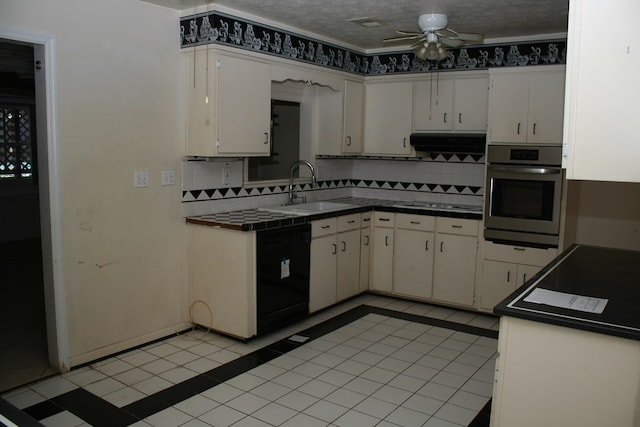 kitchen featuring stainless steel oven, a textured ceiling, sink, black dishwasher, and white cabinetry