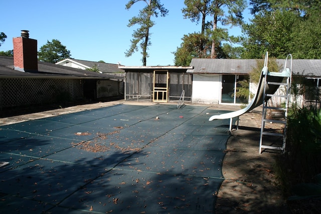 back of house featuring a covered pool