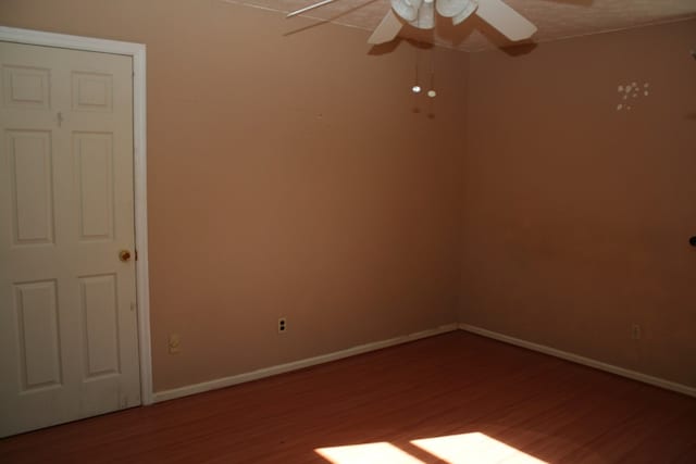 empty room with ceiling fan and hardwood / wood-style floors